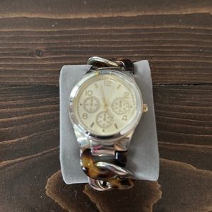 Tortoise and silver watch